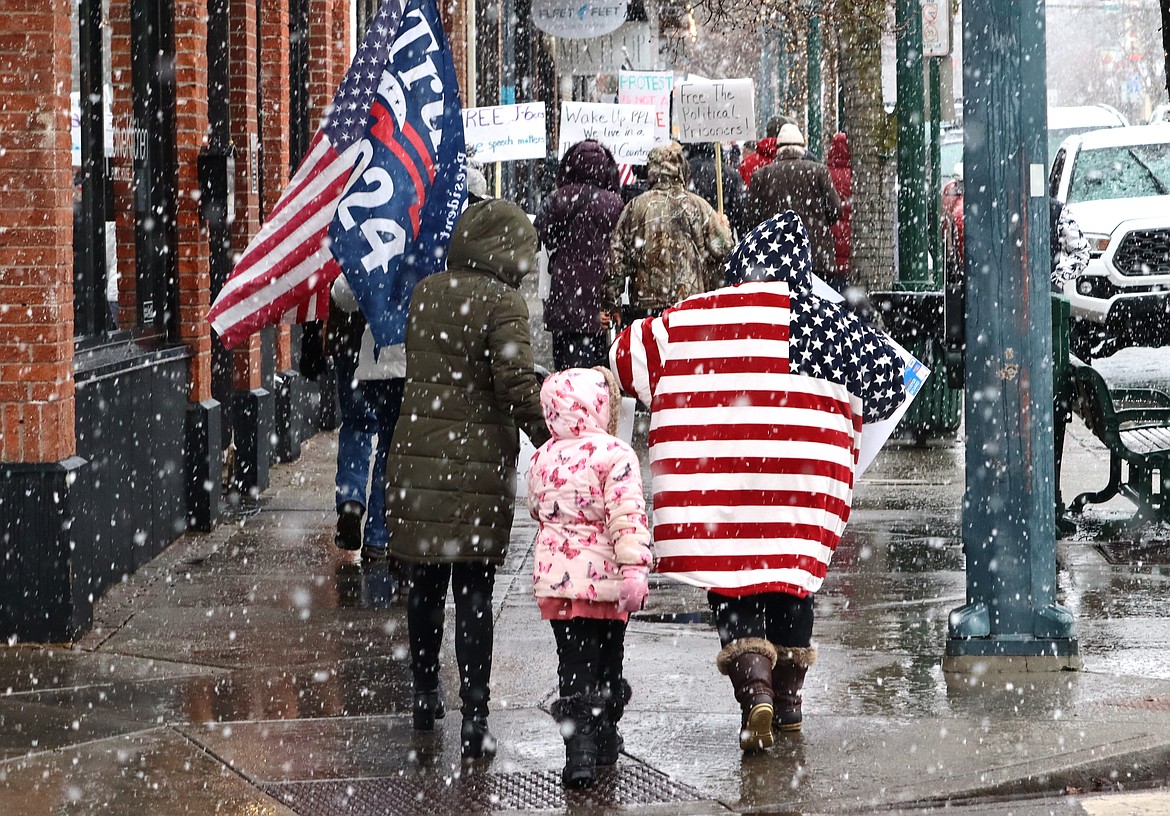 People who joined the "Justice for J6ers" rally walk on Sherman Avenue on Saturday.