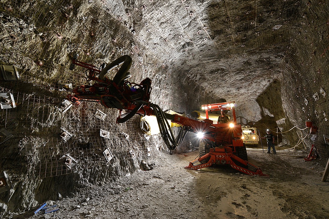 Hecla Mining Company's underhand closed bench technique has helped make safer mining shafts with fewer seismic issues and sped up mining as a result. The technique uses cemented mill tailings for backfilling areas that have been dug out. This makes the mining process in the following cuts less dangerous because the miners are always working beneath a reinforced cemented-backfill if the stress to the mine causes a rock burst or violent failure of rock.