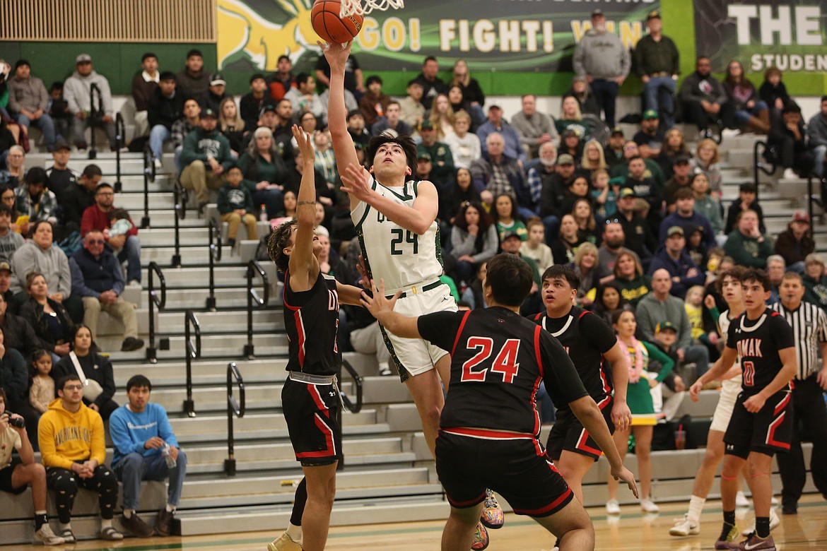 Quincy senior Julian Ibarra (24) leaps up to attempt a shot in the first quarter against Omak on Friday. Ibarra scored 15 points in the win.