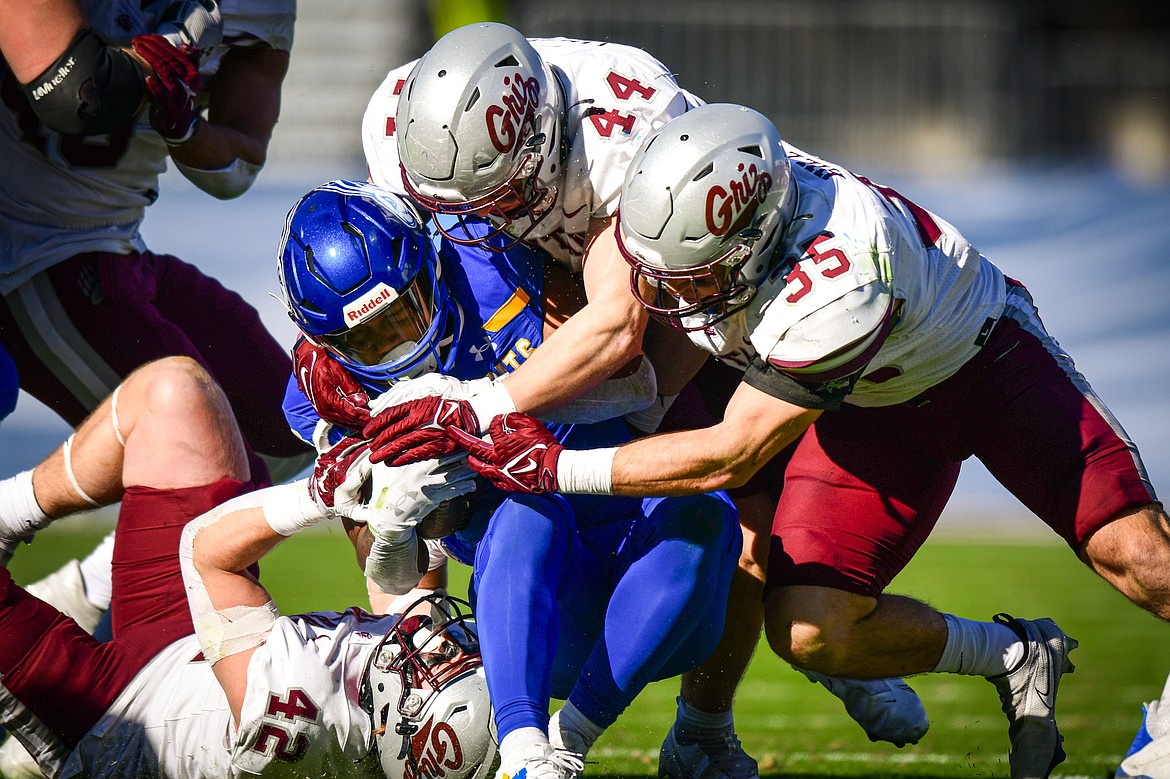 Grizzlies linebackers Riley Wilson (42), Ryan Tirrell (44) and Braxton Hill (35) stop a run by South Dakota State running back Amar Johnson (3) in the second quarter of the FCS National Championship at Toyota Stadium in Frisco, Texas on Sunday, Jan. 7. (Casey Kreider/Daily Inter Lake)