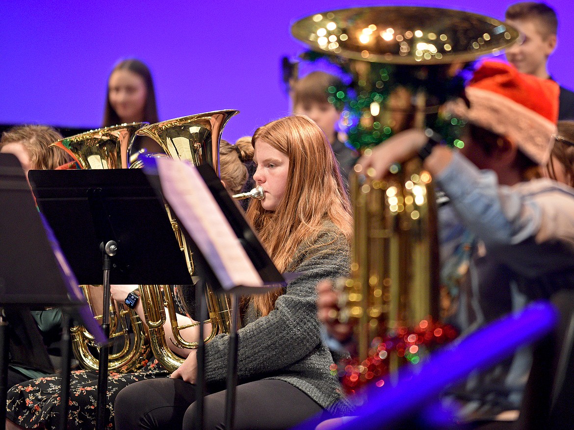 Whitefish Middle School band students Kate Sullivan (center) and Orla Sullivan (right) perform during the combined middle and high school's winter band concert in December. (Whitney England/Whitefish Pilot)
