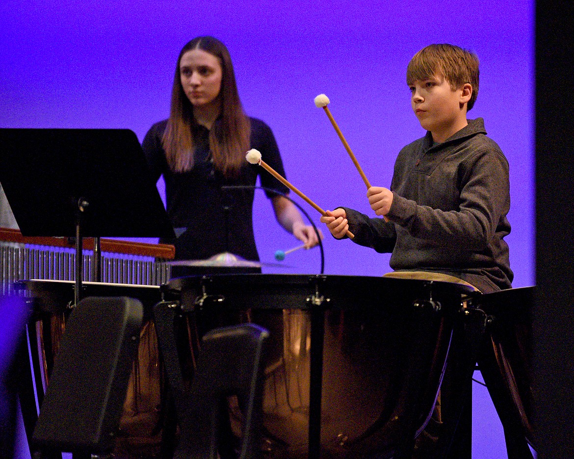 Whitefish Middle School band percussionists Allie Shors and Andrew Gibbs perform during the combined middle and high school's winter band concert in December. (Whitney England/Whitefish Pilot)