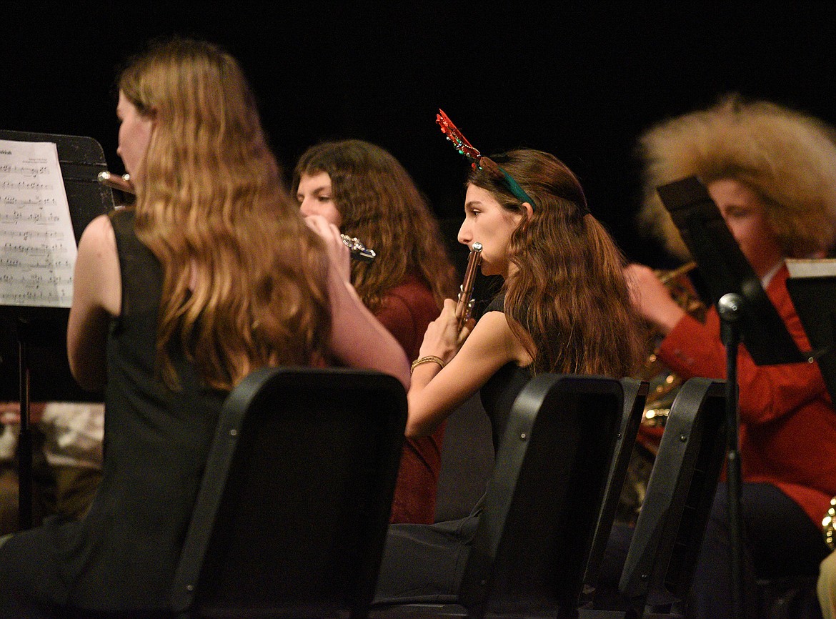 Whitefish Middle School band students Samantha Keim, Izze Short and Grace Sliman play the flute during the combined middle and high school's winter band concert in December. (Whitney England/Whitefish Pilot)