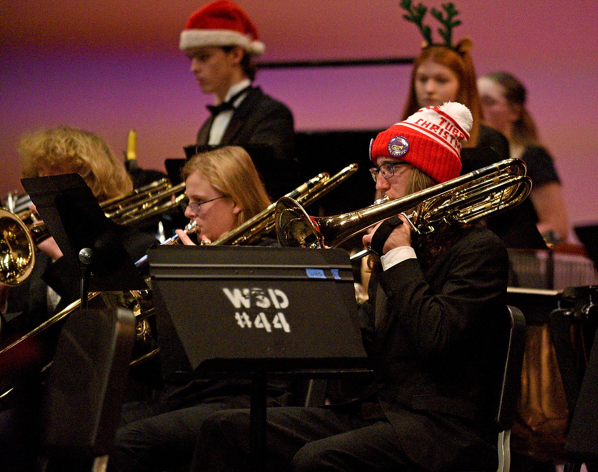 Whitefish High School band students senior Skyler Cameron and sophomore Guinevere Tomblin perform playing the trombone during the combined middle and high school's winter band concert in December. (Whitney England/Whitefish Pilot)