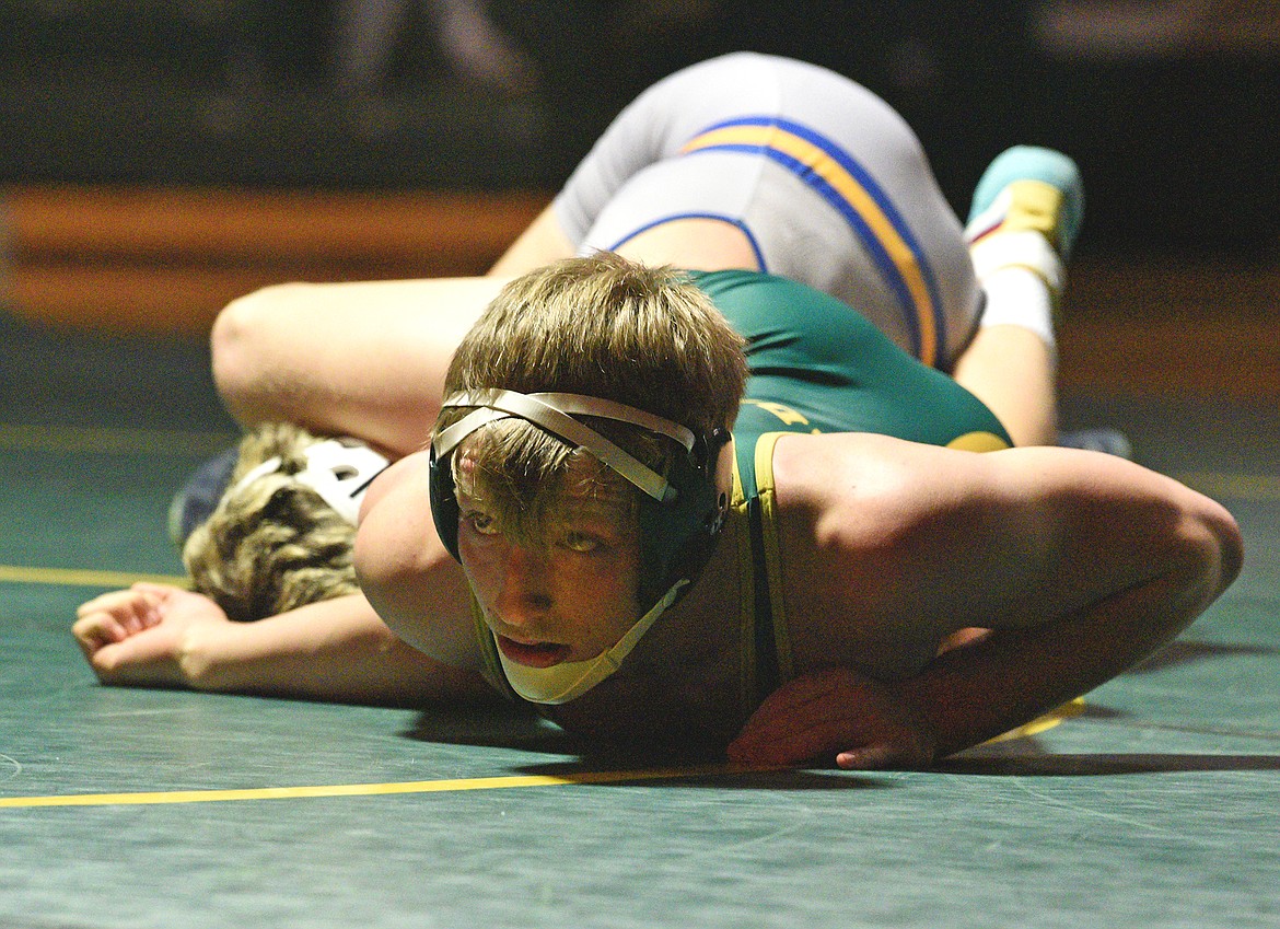 Whitefish's Henry Bennetts looks up at the ref while wrestling a Libby athlete during a triangular meet against Libby and Hamilton on Thursday, Jan. 4, 2024 in Whitefish. (Whitney England/Whitefish Pilot)