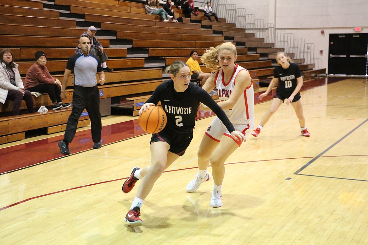 Sandpoint's Dawson Driggs drives by Chapman University forward Shanna Brown at the Hutton Sports Center on Dec. 21, 2023. Driggs, who had a career-high 13 points and three 3-pointers in the 72-69 loss to the Panthers, is excelling in her senior season for the Pirates.