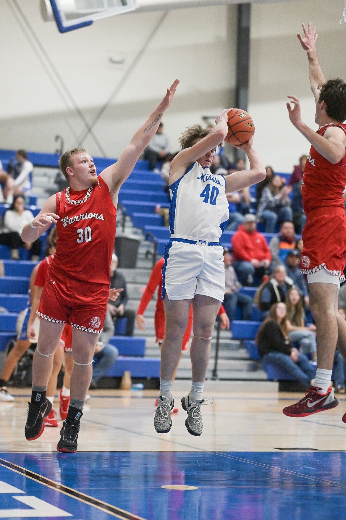 Warrior Jake Knoll tries to defend the net from Bulldog Codiak Killorn in last week's Arlee/Mission contest. (Christa Umphrey photo)