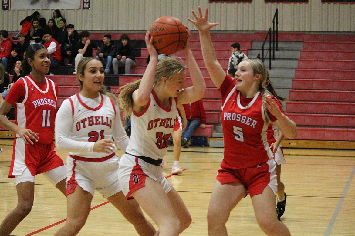 Othello’s Riley Farman (34) fights her way to the basket against Prosser Friday.