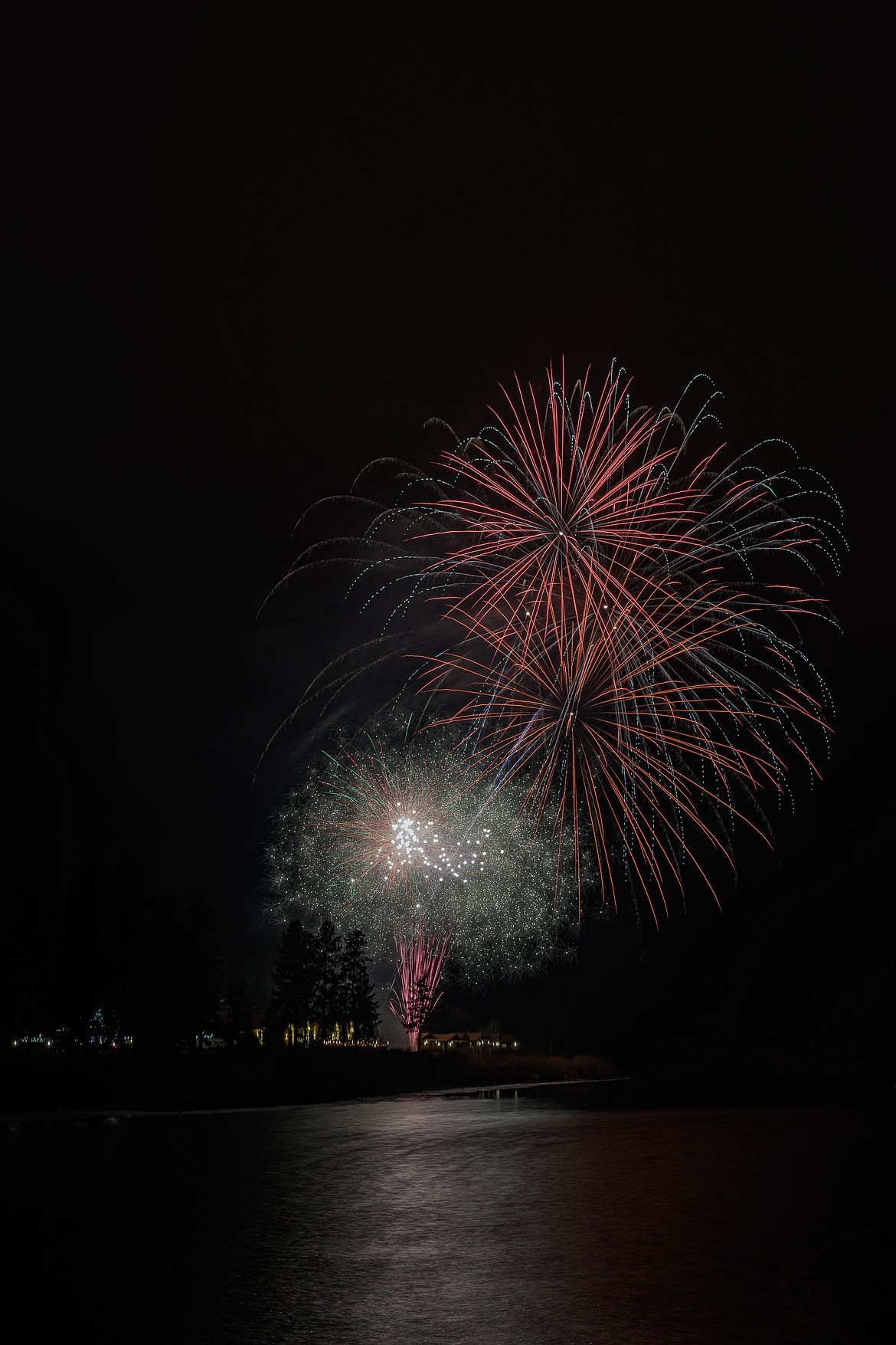 Fireworks explode over the Clark Fork River near Quinn's Hot Springs Resort during a New Year's Eve celebration Jan. 1, 2024. (Tracy Scott/Valley Press)