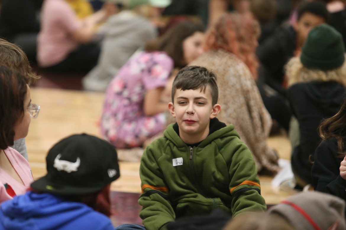 Dominic Morales discusses his findings with fellow sixth graders during the Connecting the Dots program Tuesday at Lakes Middle School. The program focuses on improving school culture and student relationships through kindness and empathy.