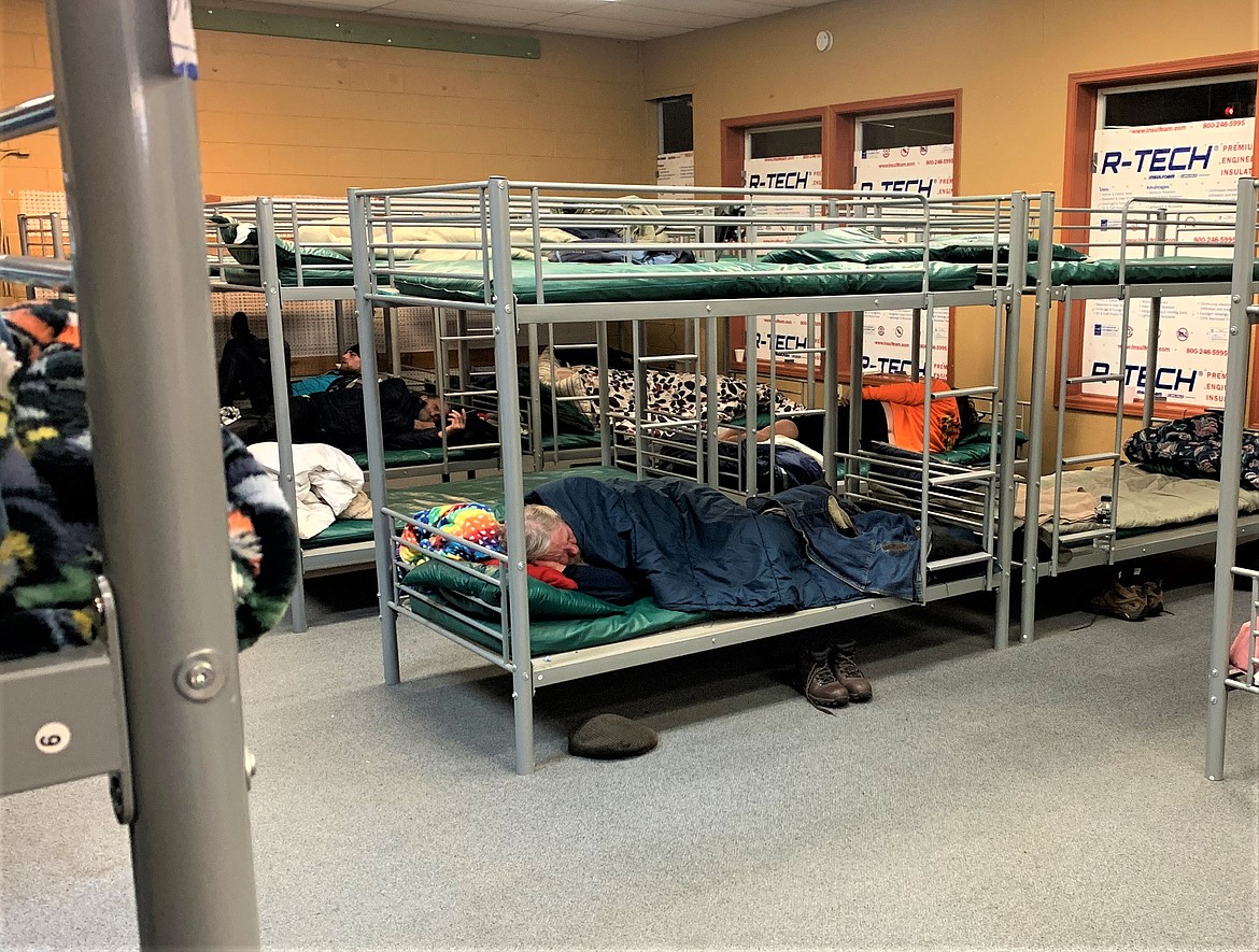 A man pulls a sleeping bag up tight as he sleeps at the St. Vincent de Paul North Idaho warming shelter in Post Falls on a cold night in February 2023.