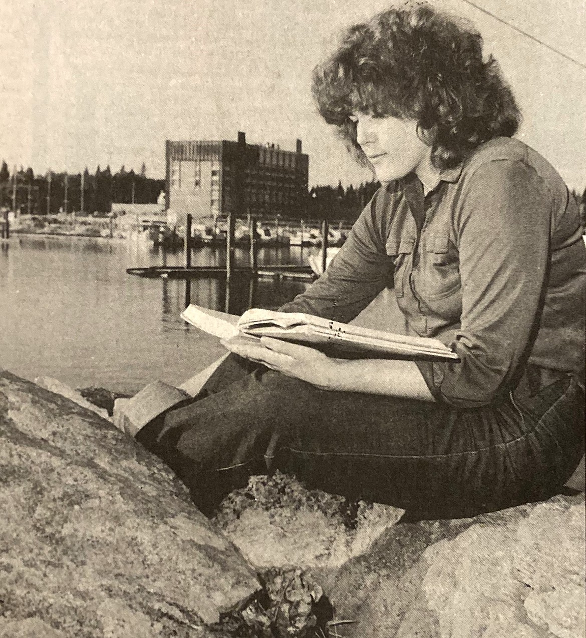 North Idaho College sophomore Cindy Barnes studied in the October 1978 sunshine on Tubbs Hill with the old North Shore Resort Hotel in the background.