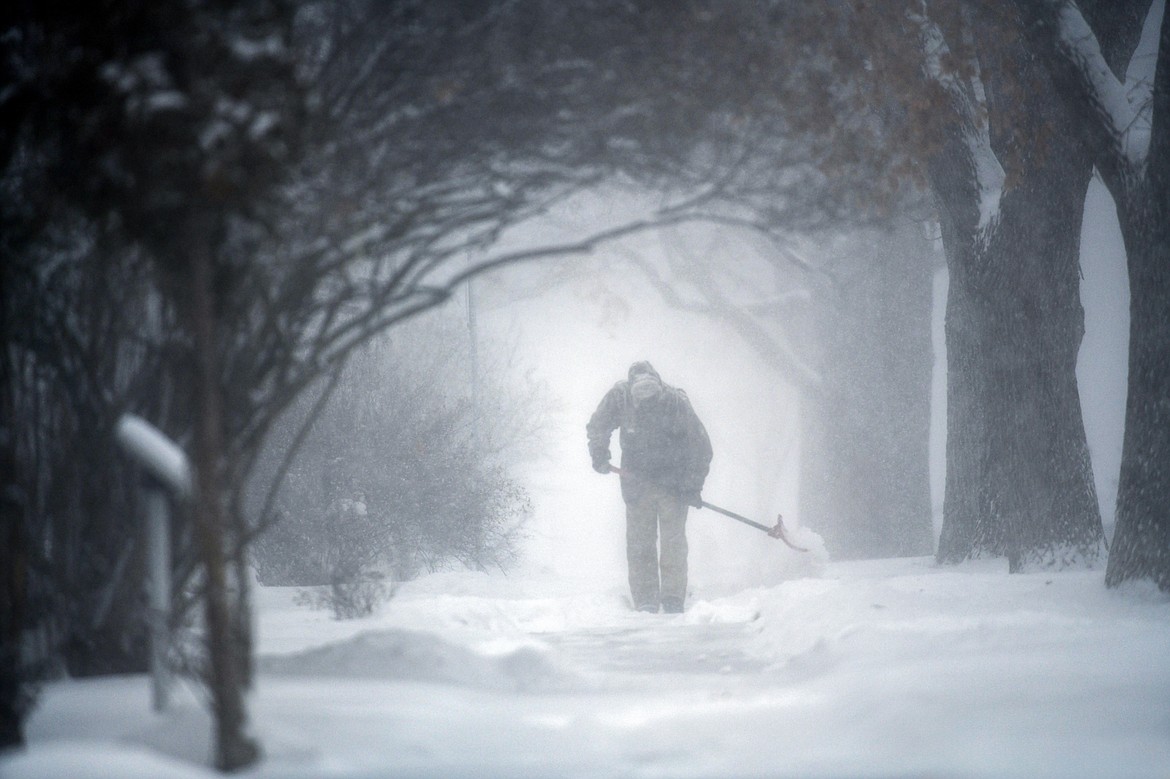 A resident of Third Avenue East shovels snow on Thursday, Jan. 11. (Casey Kreider/Daily Inter Lake)