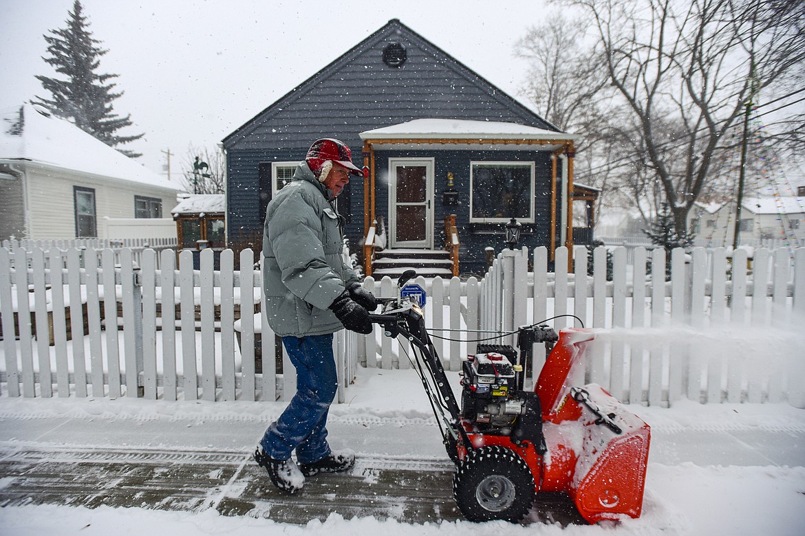 Martin Rippens clears snow in front of his home along Third Avenue East in Kalispell on Thursday, Jan. 11. (Casey Kreider/Daily Inter Lake)