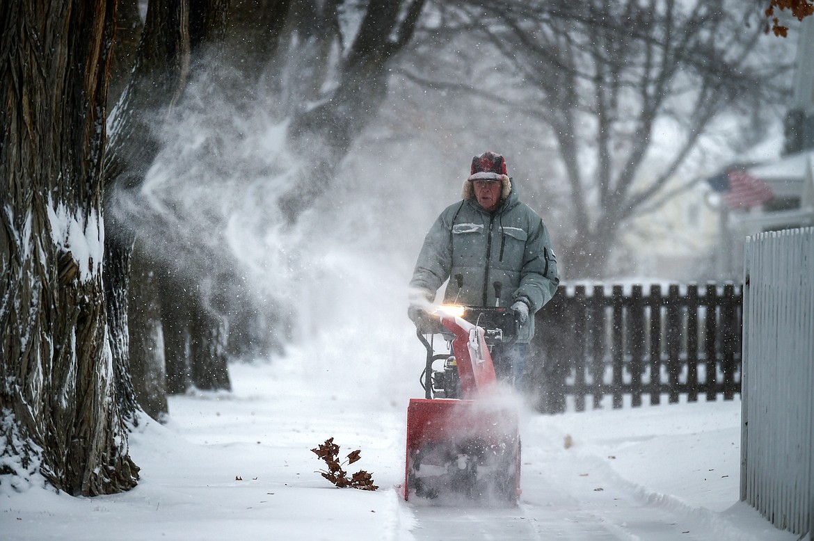 Martin Rippens clears snow in front of his home along Third Avenue East in Kalispell on Thursday, Jan. 11. (Casey Kreider/Daily Inter Lake)