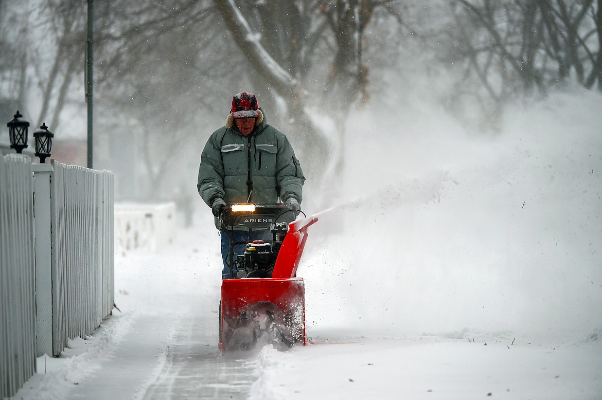 Martin Rippens clears snow in front of his home along Third Avenue East in Kalispell on Thursday, Jan. 11. (Casey Kreider/Daily Inter Lake)