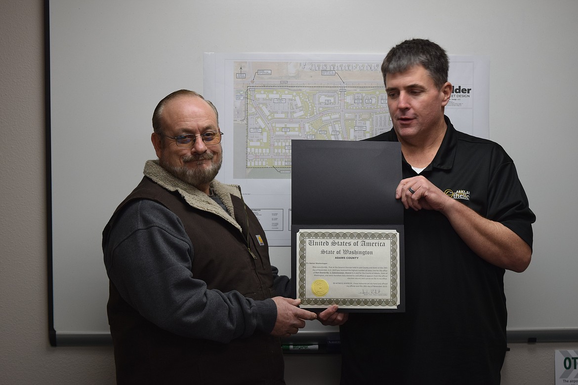 Newly elected Port of Othello Commissioner Homer Montemayor, left, was sworn in by the port’s Executive Director Chris Faix, right, in the port’s offices in Othello Tuesday.