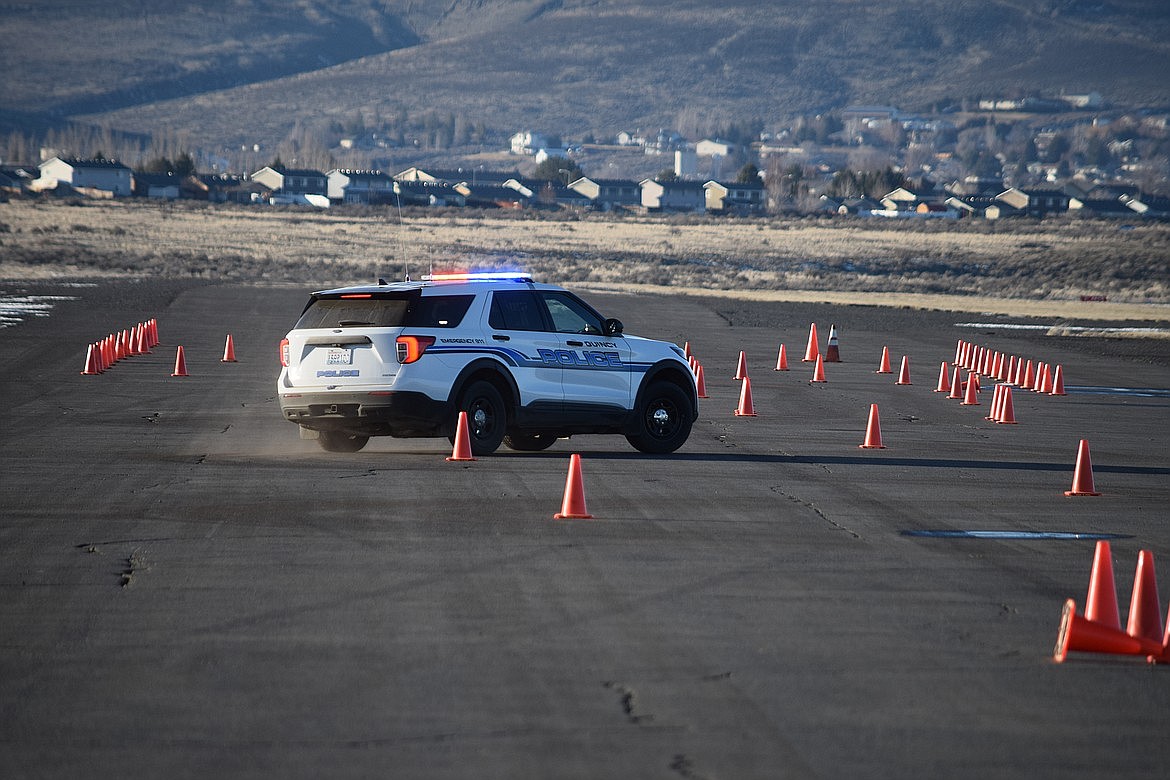 A Quincy Police car makes a tight turn on the slalom portion of a high-speed driving course during the training event at the Ephrata airport in early 2022. Officers train to focus on public and officer safety regularly and follow strict guidelines for use of force. Investigations after such uses of force are conducted by a regional team with participation from civilians to ensure the inquiries are conducted properly.