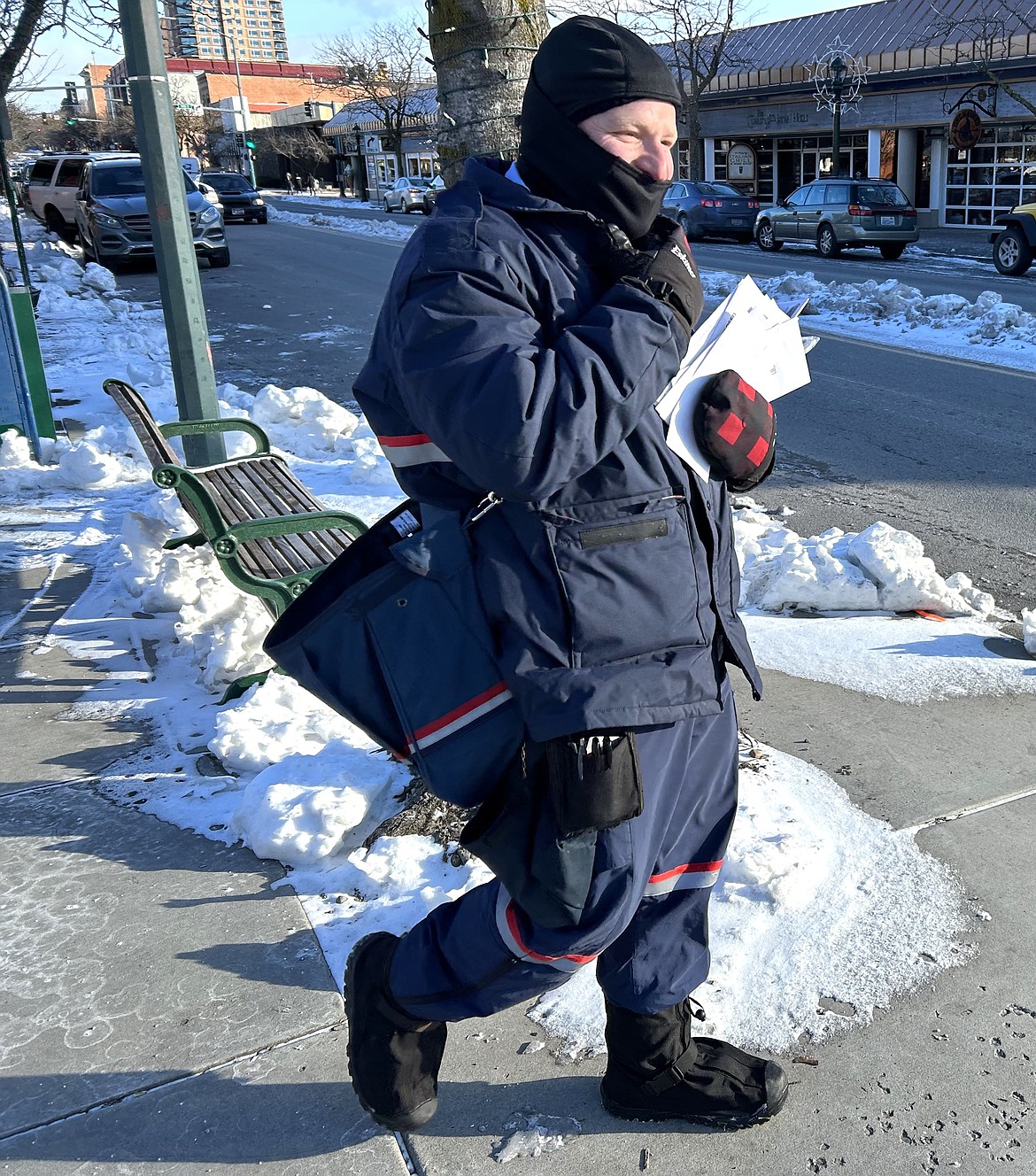 Alex Paniagua is bundled up as he delivers mail in downtown Coeur d'Alene on Friday.
