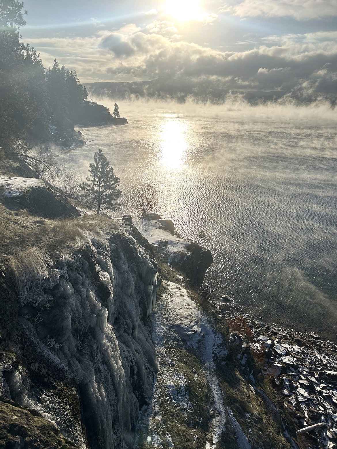 Ice covers a section of Tubbs Hill as the sunlight reflects on Lake Coeur d'Alene on Friday.