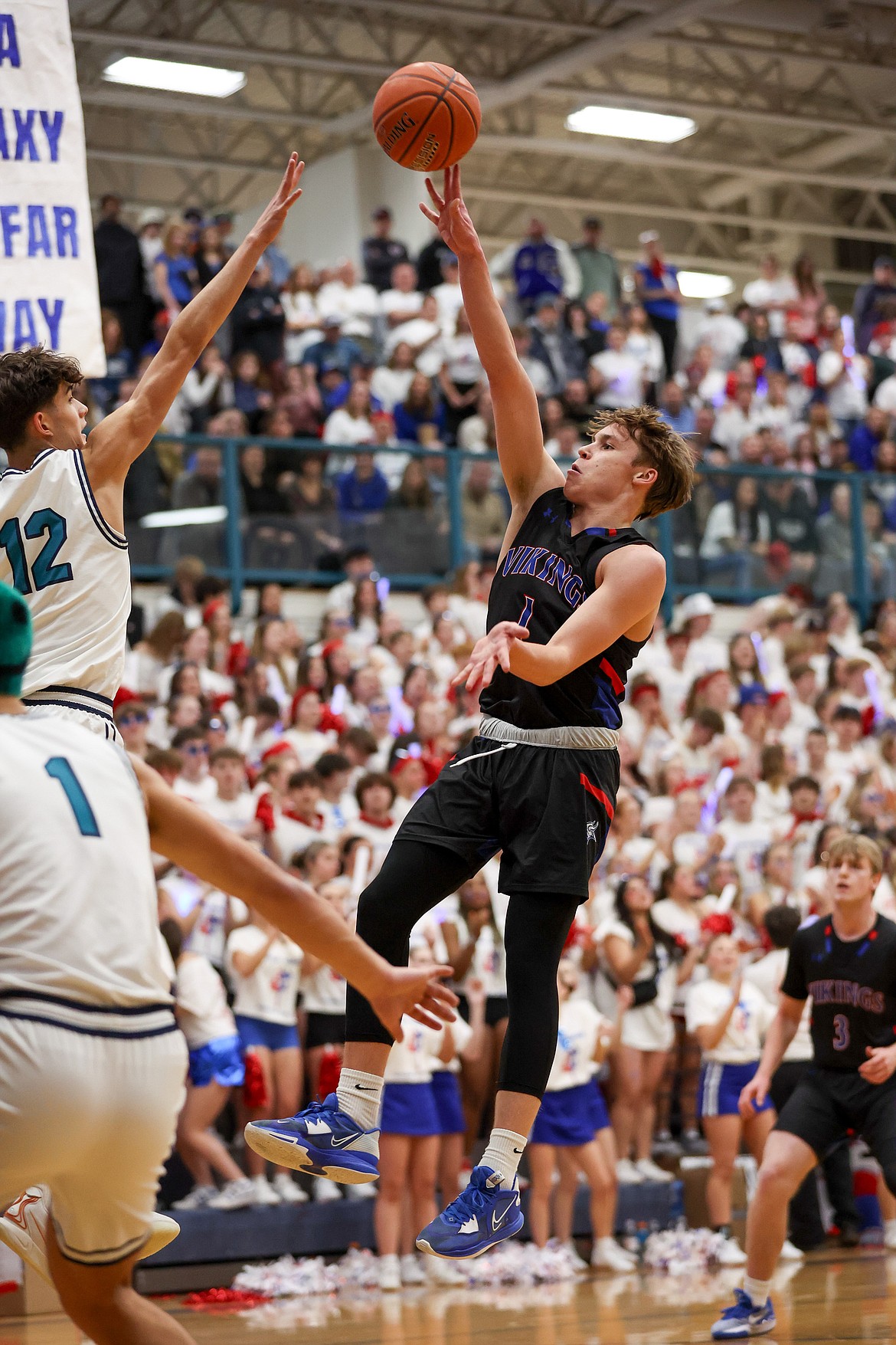 JASON DUCHOW PHOTOGRAPHY
Senior Logan Orchard of Coeur d'Alene hits a floater in the lane as junior Carter Kloos of Lake City defends in the Fight for the Fish game at Lake City High.