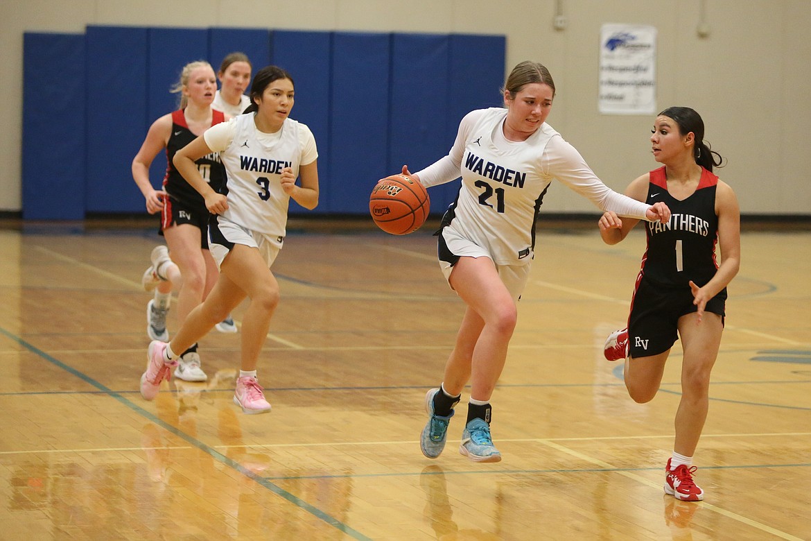 Warden freshman Makenna Klitzke (21) dribbles the ball down the floor in transition against River View Friday night.