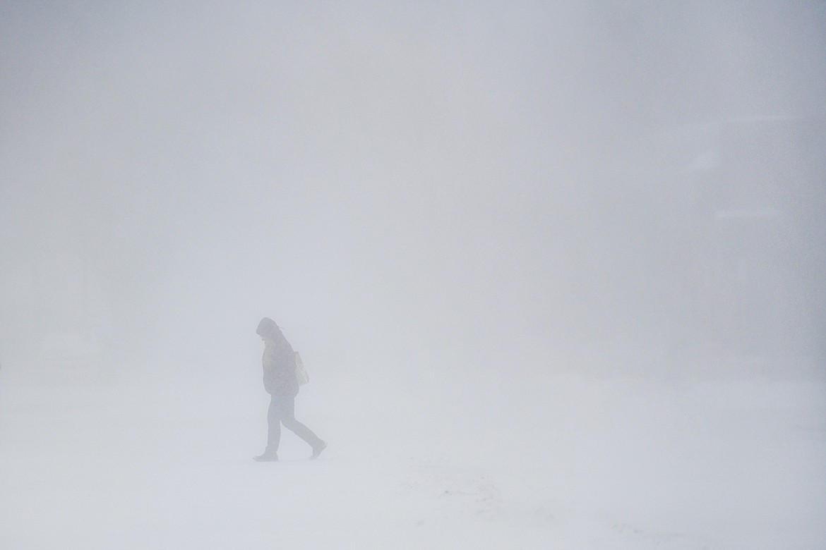 A pedestrian crosses Fifth Street East along South Main Street during whiteout conditions on Thursday, Jan. 11. (Casey Kreider/Daily Inter Lake)