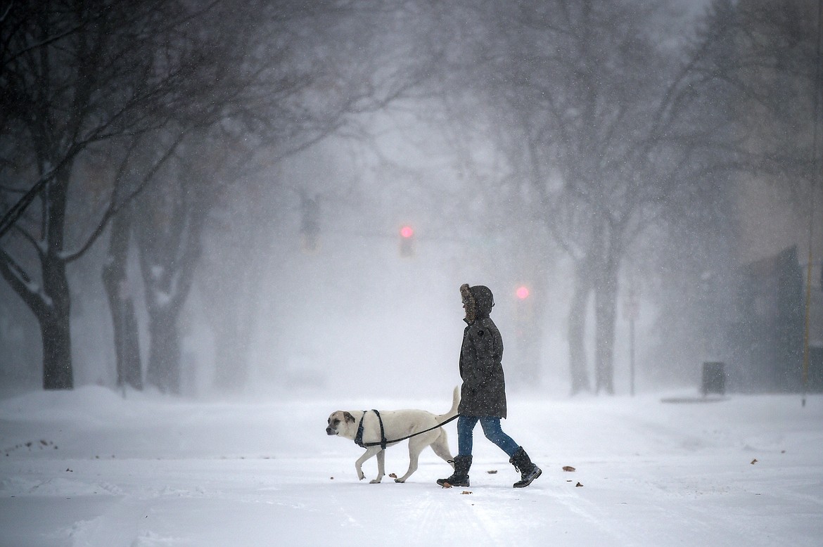Macy Warr and her dog Lucy walk along First Avenue West on Thursday, Jan. 11. (Casey Kreider/Daily Inter Lake)