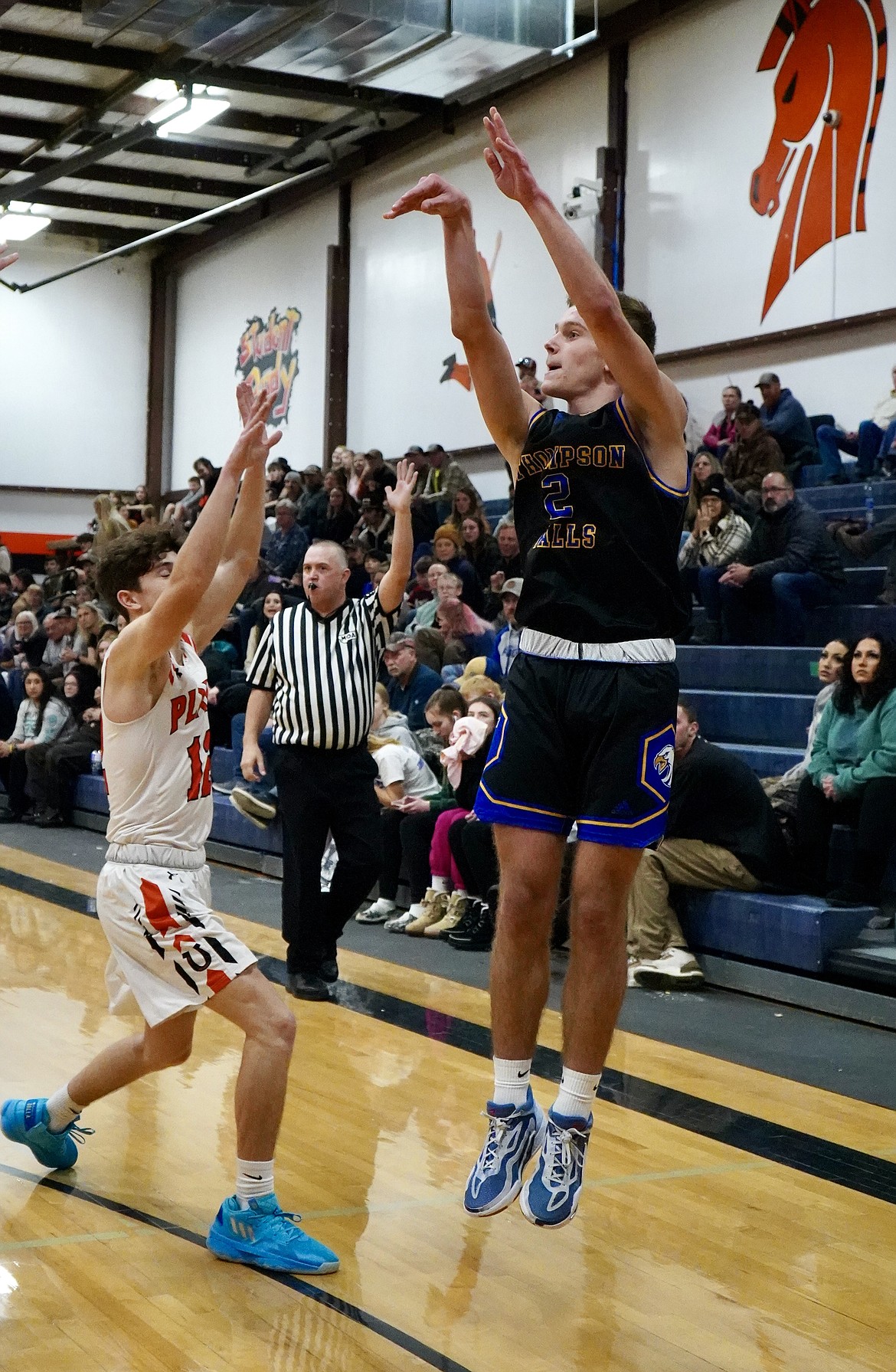 Thompson Falls guard Nick Tessier shoots over Plains guard Darren Standeford during their game this past Thursday in Plains.  (Couresy photo)