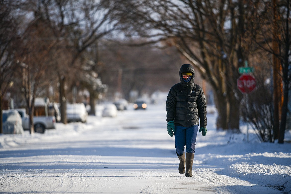 Dylan Ratliff bundles up for a walk back to his residence along Fifth Street West in Kalispell on Friday, Jan. 12. (Casey Kreider/Daily Inter Lake)