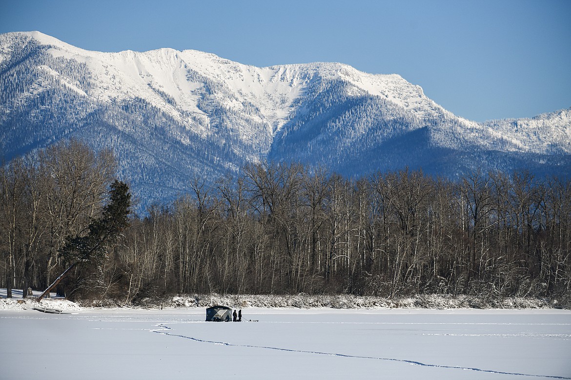 Ice fishermen wait for bites in subzero temperatures on the frozen surface of Church Slough along the Flathead River on Saturday, Jan. 13. (Casey Kreider/Daily Inter Lake)