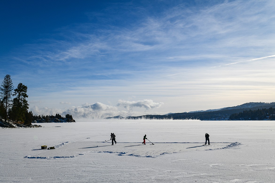 Brian, Corbin and Elizabeth Lockwood ice skate around the frozen surface of Flathead Lake's Somers Bay on Saturday, Jan. 13. (Casey Kreider/Daily Inter Lake)