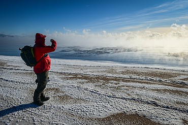 David Steele takes a picture as steam fog rises off Flathead Lake at Somers Beach State Park on Saturday, Jan. 13. Steele and his sister Beth were looking to go ice skating and opted to go to the Somers Boat Launch for better skating conditions. (Casey Kreider/Daily Inter Lake)