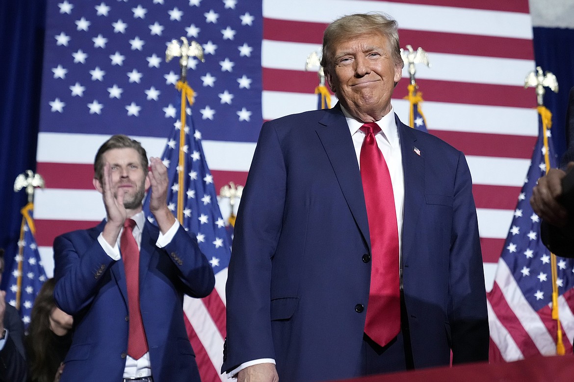 Republican presidential candidate former President Donald Trump stands on stage as he speaks at a caucus night party in Des Moines, Iowa, Monday, Jan. 15, 2024. (AP Photo/Andrew Harnik)