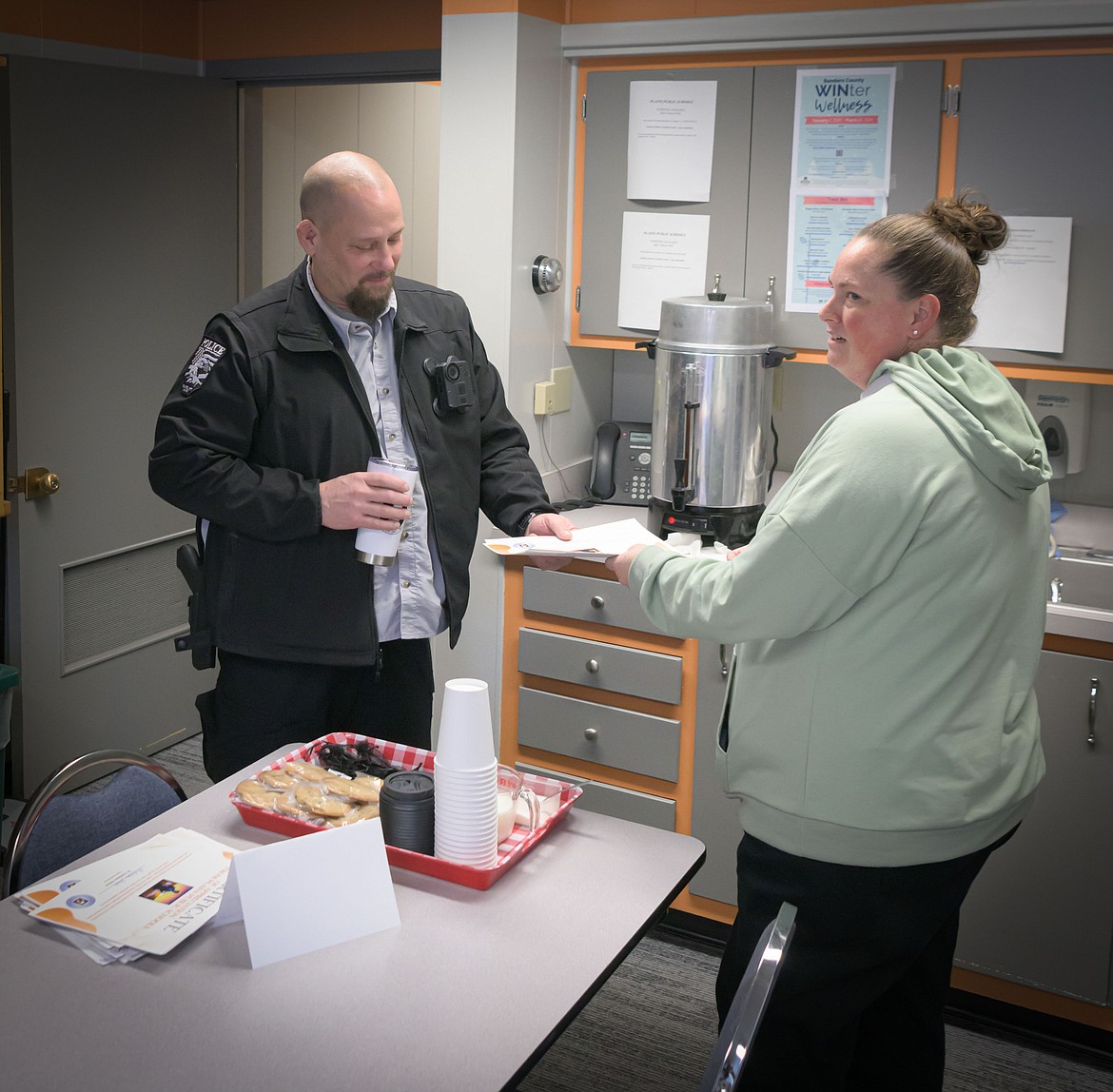 Plains Police Chief Brian Josephson accepting a certificate of appreciation from Kati Mitchell. (Tracy Scott/Valley Press)