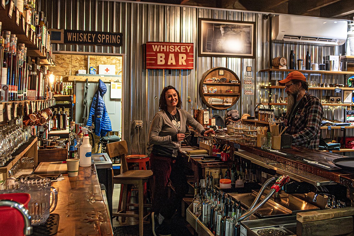 Manager Jessica Sorenson takes a moment from serving a customer to flash a smile at Glacier Distilling Company on Tuesday, Jan. 9. (Avery Howe photo)