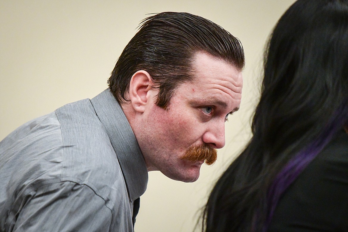 Steven Justin Hedrick speaks to his attorney during his trial for deliberate homicide at Flathead County District Court on Tuesday, Jan. 16. (Casey Kreider/Daily Inter Lake)