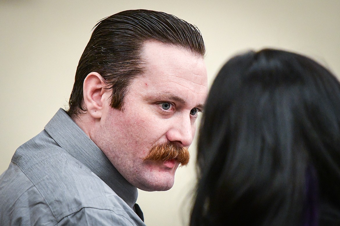 Steven Justin Hedrick speaks to his attorney during his trial for deliberate homicide at Flathead County District Court on Tuesday, Jan. 16. (Casey Kreider/Daily Inter Lake)