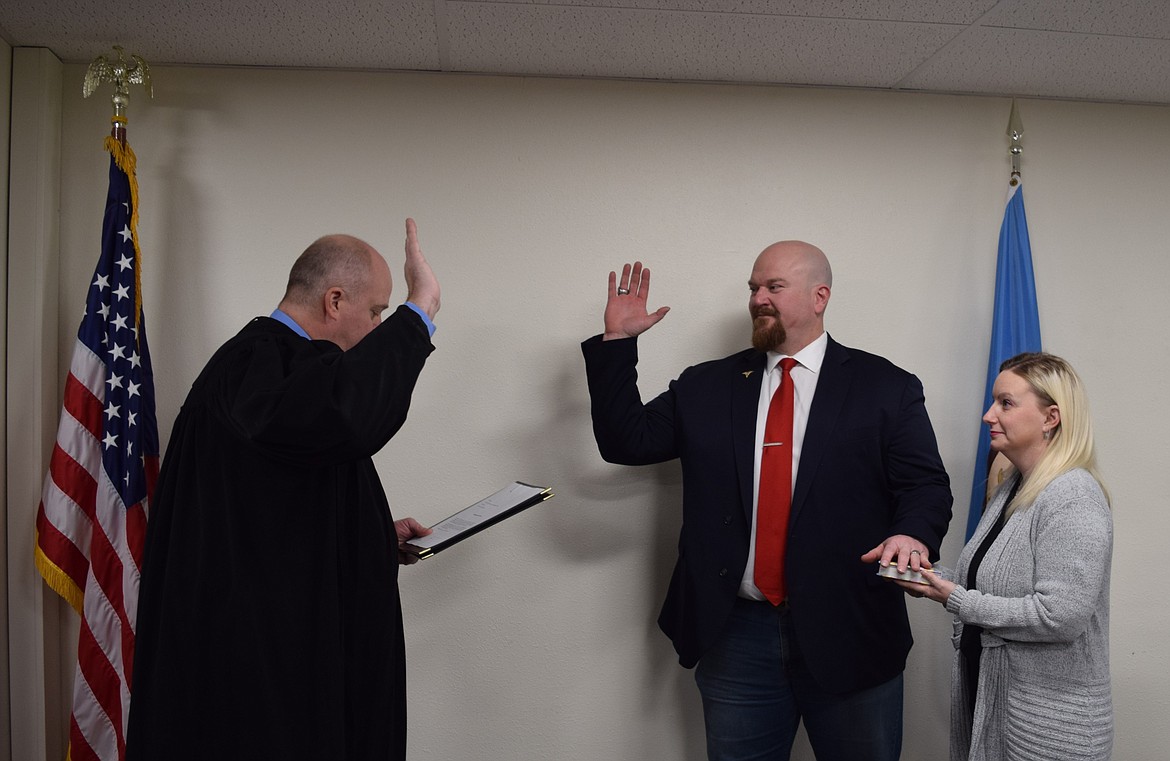 Grant County Judge Brian Gwinn, left, swears in Moses Lake Irrigation and Rehabilitation District Board Member Joe Ketterer Tuesday at the Grant County Courthouse.