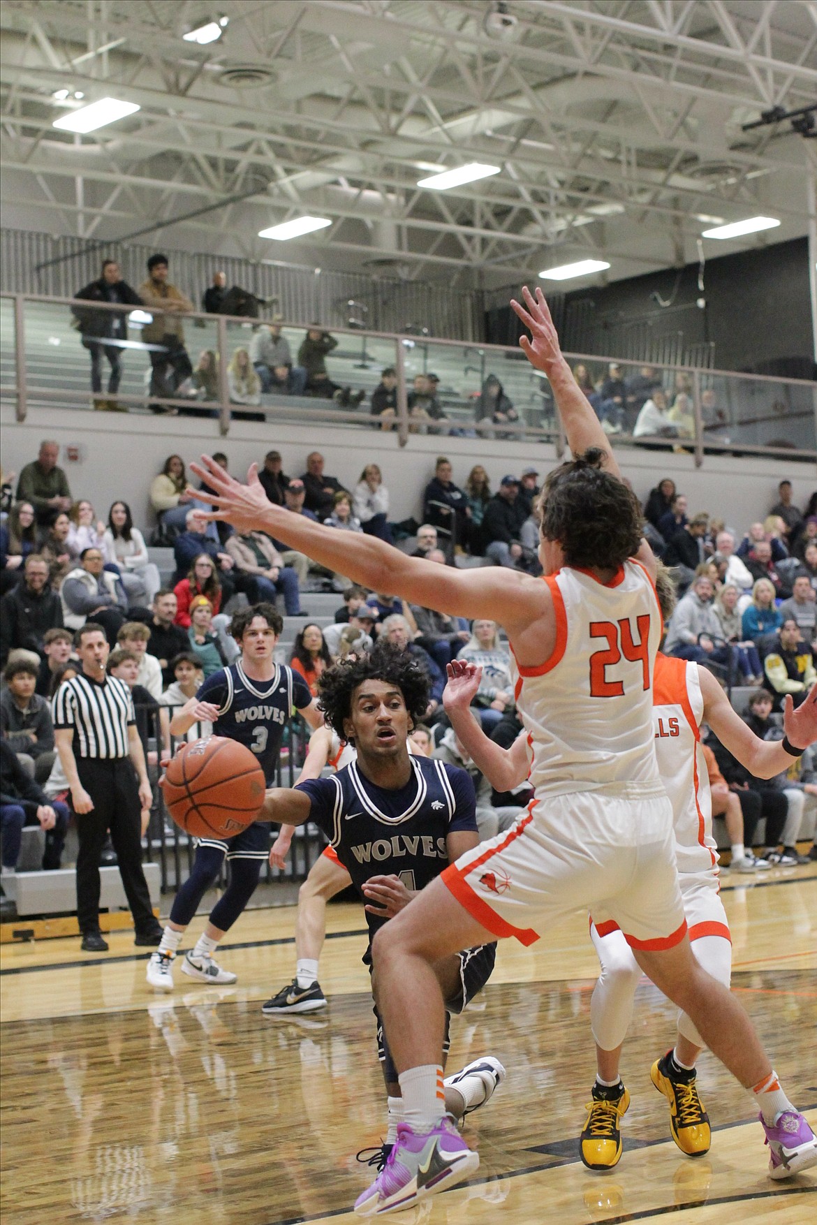 MARK NELKE/Press
Cason Miller (4) of Lake City passes past Alex Shields (24) of Post Falls on Tuesday night in Post Falls.