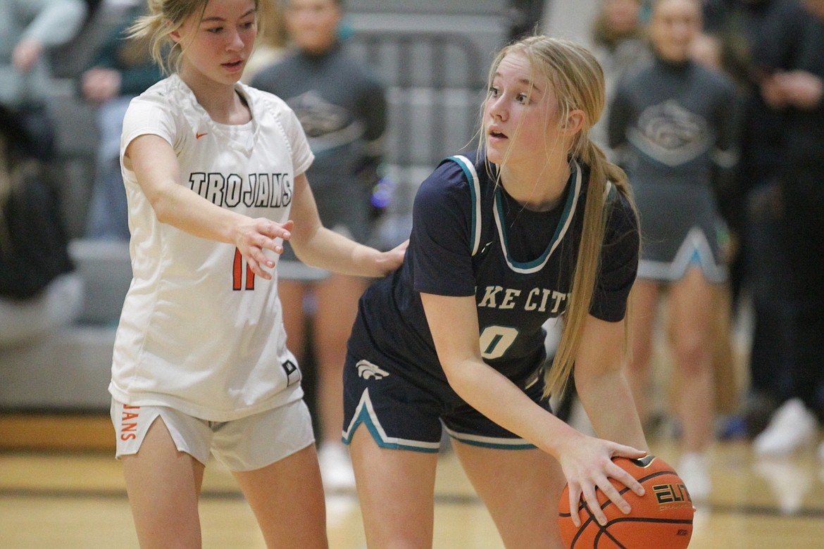 MARK NELKE/Press
Macy Murphey (0) of Lake City looks to pass as Olivia Hollenbeck (11) of Post Falls defends on Tuesday night at Post Falls.