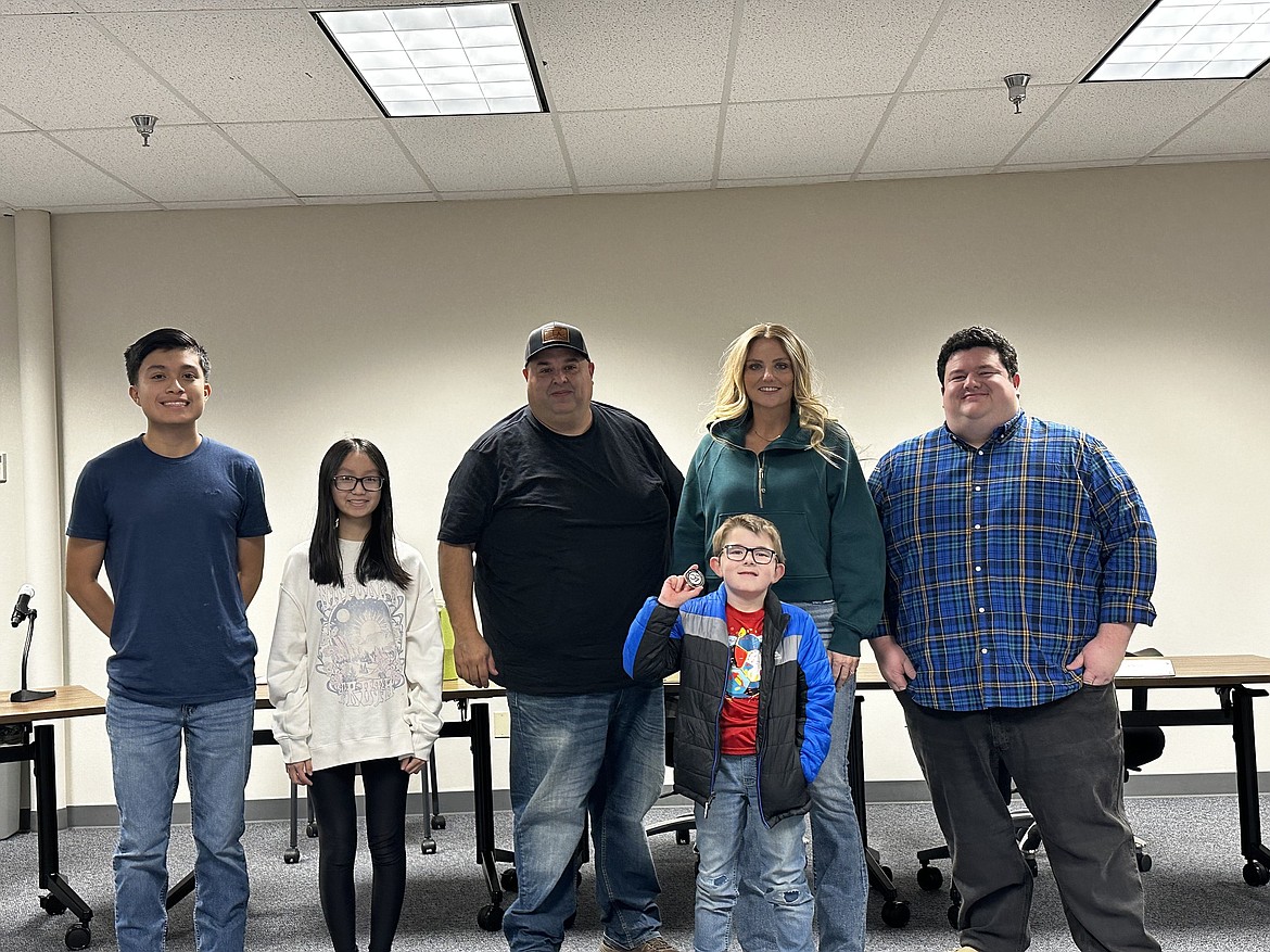 Dmitrius Tzemos, front, shows off the award he received for his efforts to collect food for the Othello Christmas Basket project. He’s accompanied by, from left, Othello School Board student representatives Sebastian Serrano-Avelar and Audrey Jahns, and board members Isauro Pruneda Jr., Lindsy Prows and Aaron Gerber.