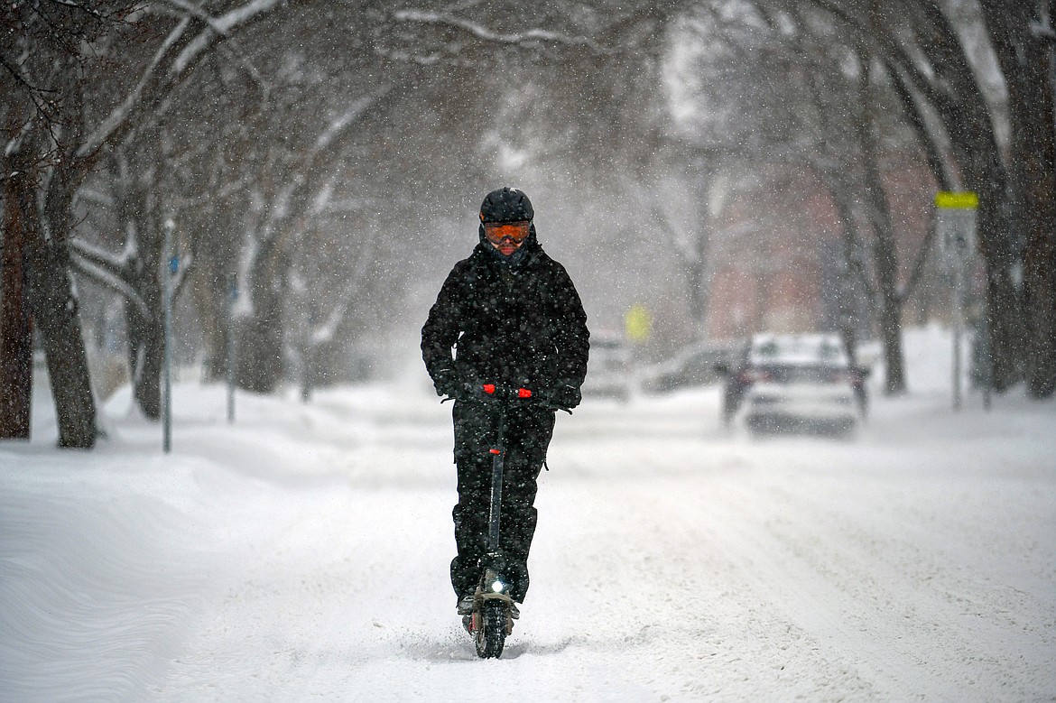 John K. rides a scooter back to his residence along Fifth Avenue West during a snowstorm on Wednesday, Jan. 17. (Casey Kreider/Daily Inter Lake)