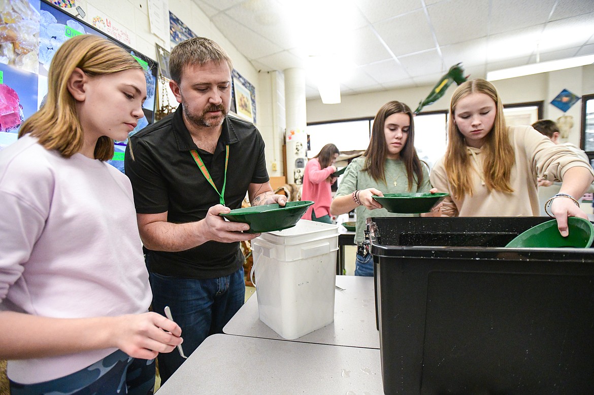 Kalispell Middle School teacher Kris Schreiner demonstrates how to pan through material in search of minerals in his eighth-grade Montana History class at on Tuesday, Jan. 16. (Casey Kreider/Daily Inter Lake)