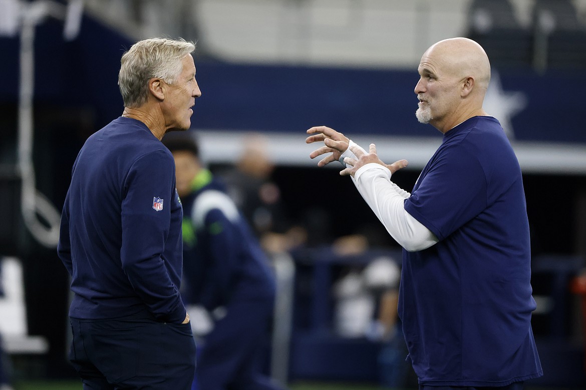 MICHAEL AINSWORTH/Associated Press
Former Seattle Seahawks coach Pete Carroll, left, and Dallas Cowboys defensive coordinator Dan Quinn, right, talk on the field during warmups before a 2022 preseason game in Arlington, Texas. Quinn is interviewing this week to replace Carroll as Seahawks coach this week.