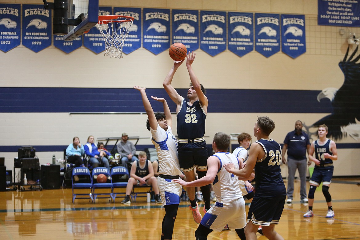 MLCA/CCS sophomore Dennis Gulenko (32) attempts a jump shot against Soap Lake Tuesday night.