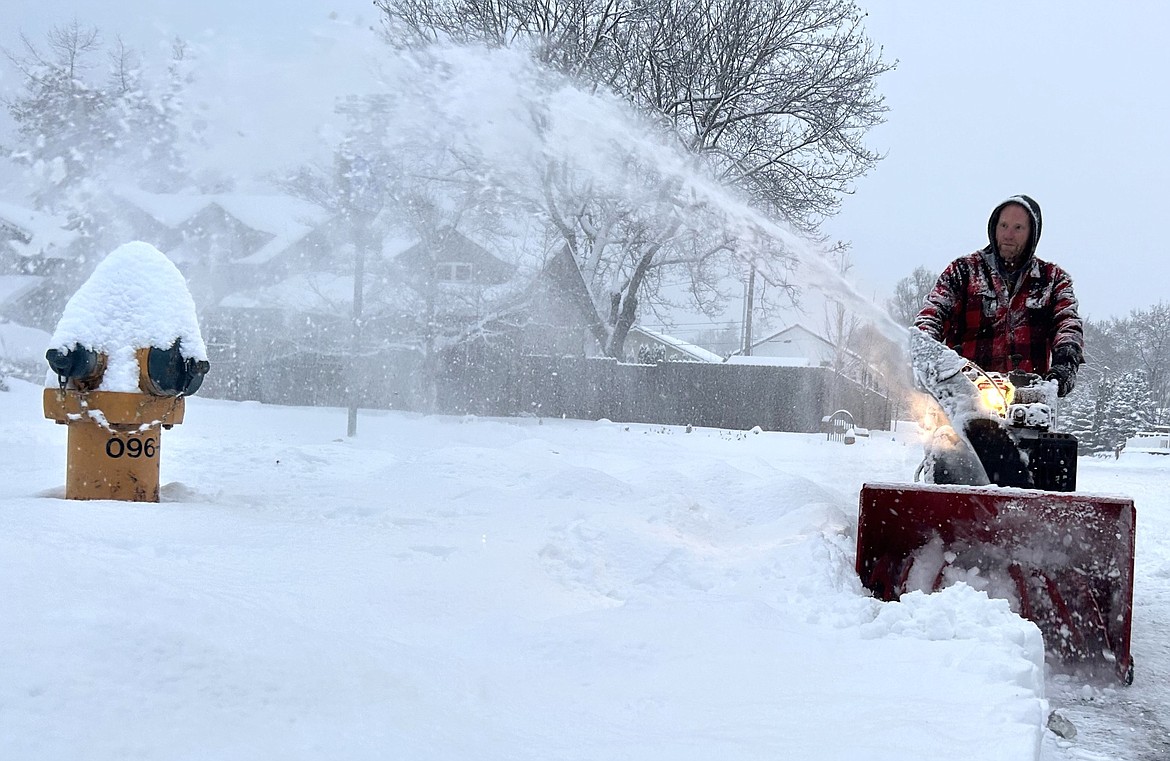 Bruce Normstrom mans a snowblower near 19th Street and Mullan Avenue on Wednesday.