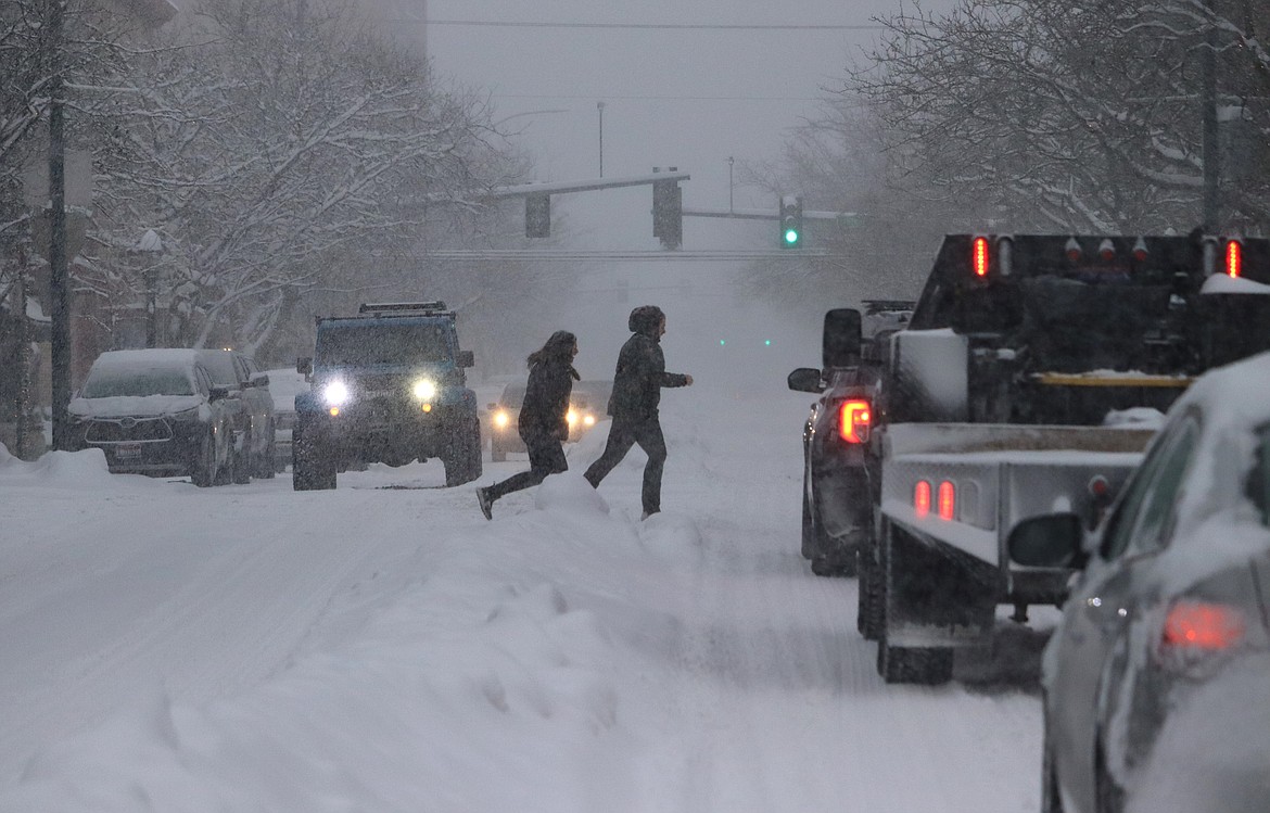 People run across Sherman Avenue during Wednesday's blizzard.