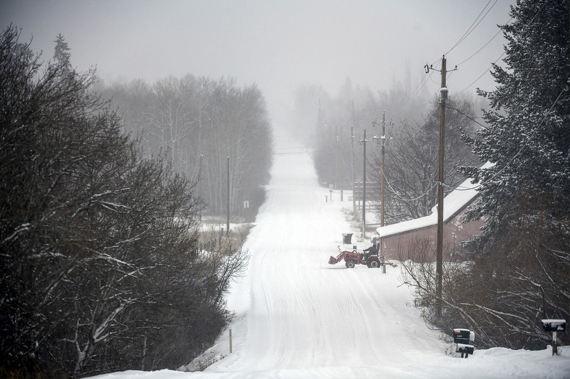 A resident of Two Mile Drive clears his driveway during a snowstorm on Wednesday, Jan. 17. (Casey Kreider/Daily Inter Lake)