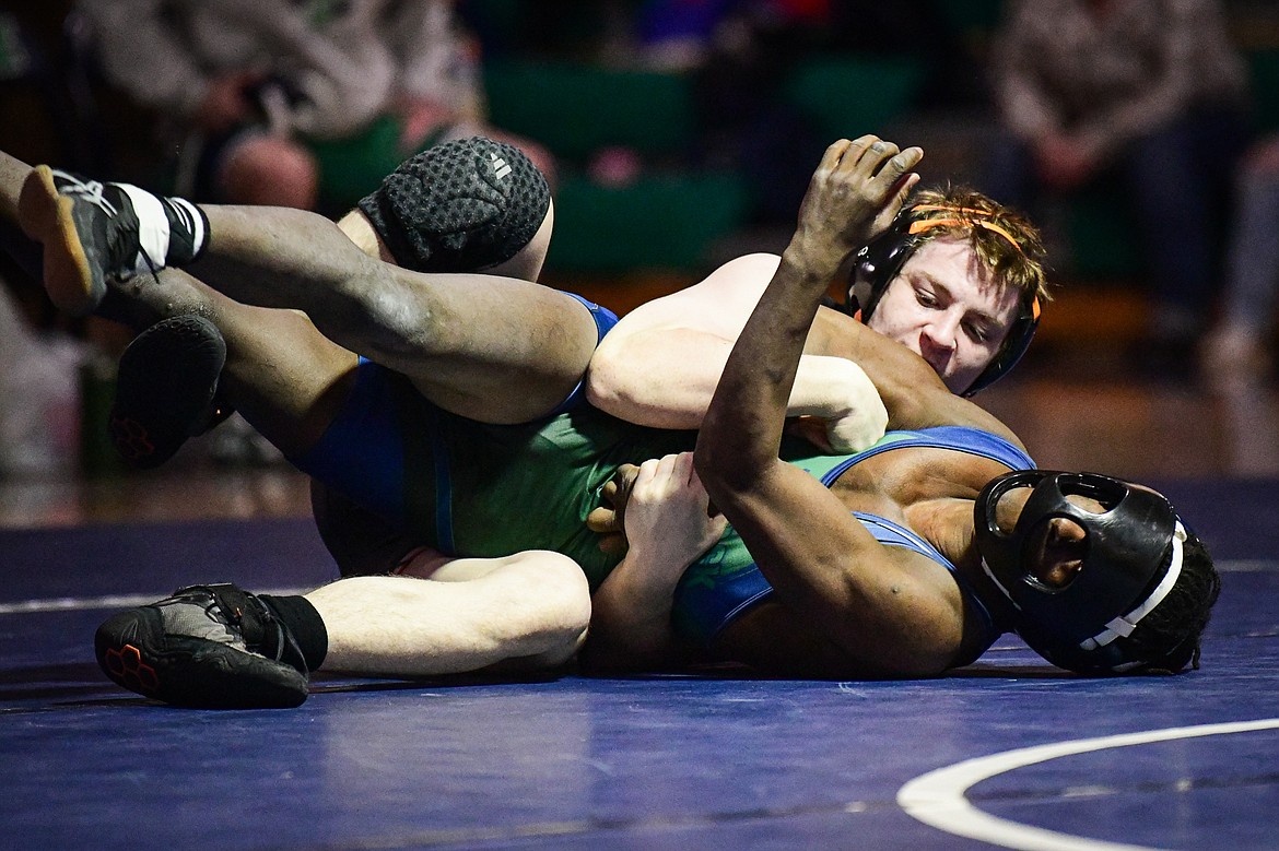 Flathead's Aiden Downing wrestles Glacier's Emery Bergstedt at 132 lbs. at Glacier High School on Thursday, Jan. 18. (Casey Kreider/Daily Inter Lake)